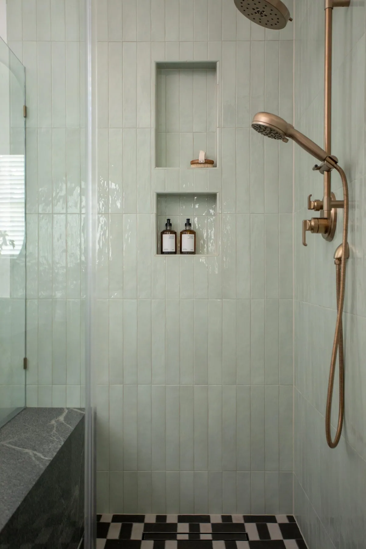 Celadon tile shower niches with brass fixtures