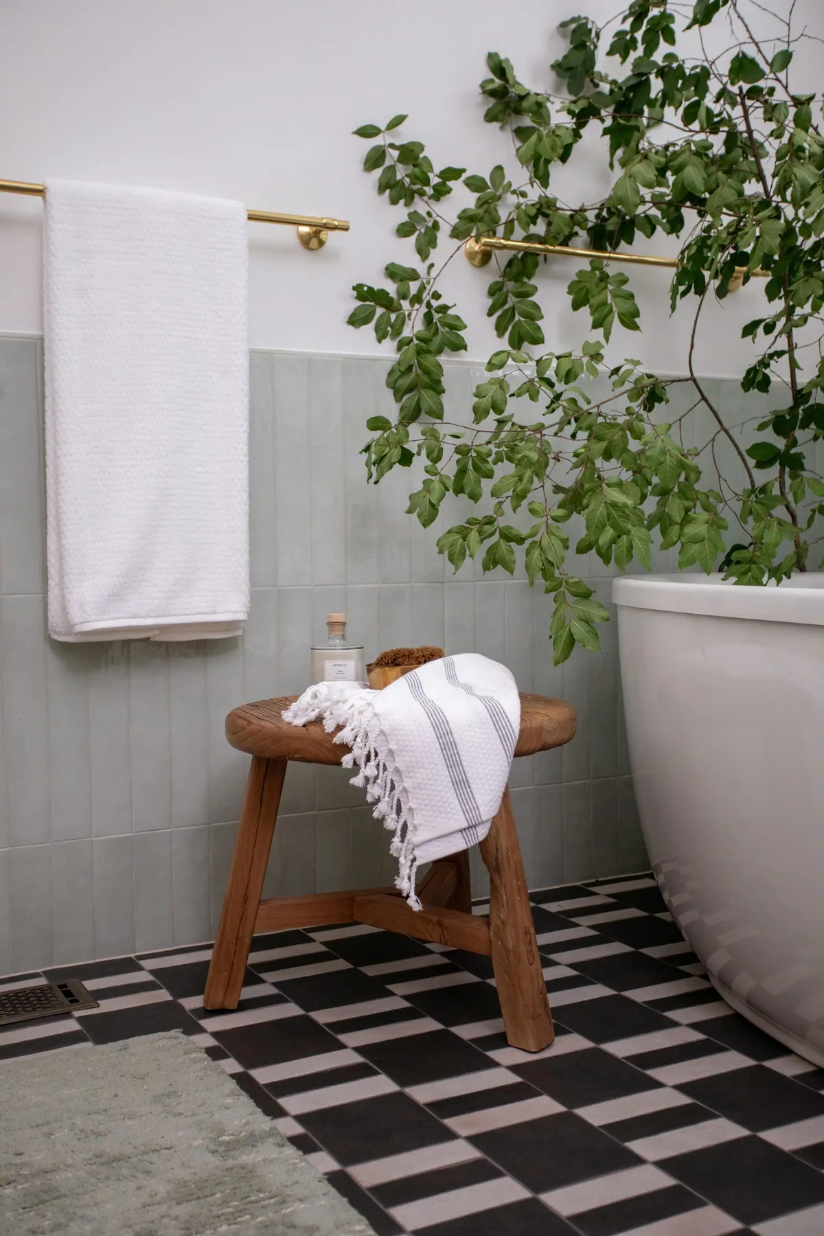 Handmade Spanish floor tile in a custom pattern with a brass towel bar