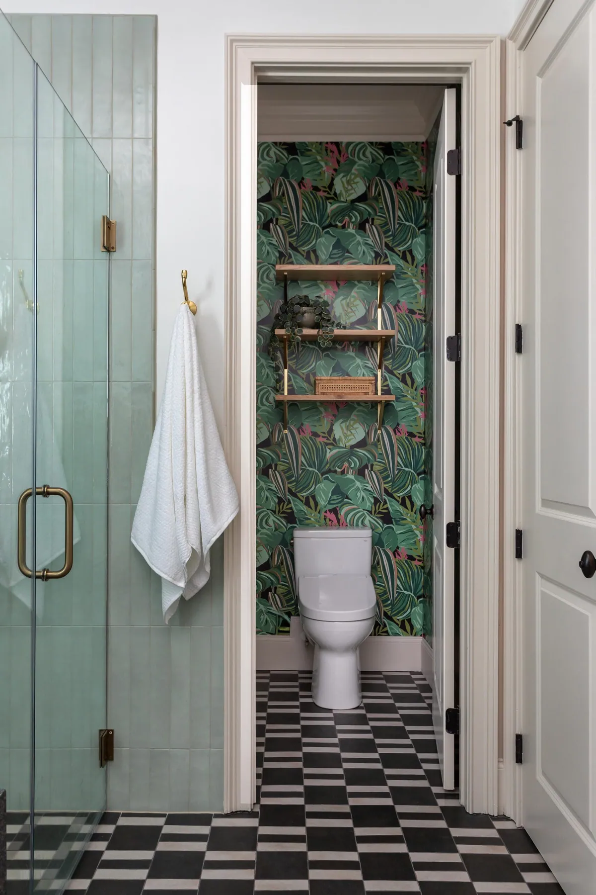 Water closet with colorful palm wallpaper