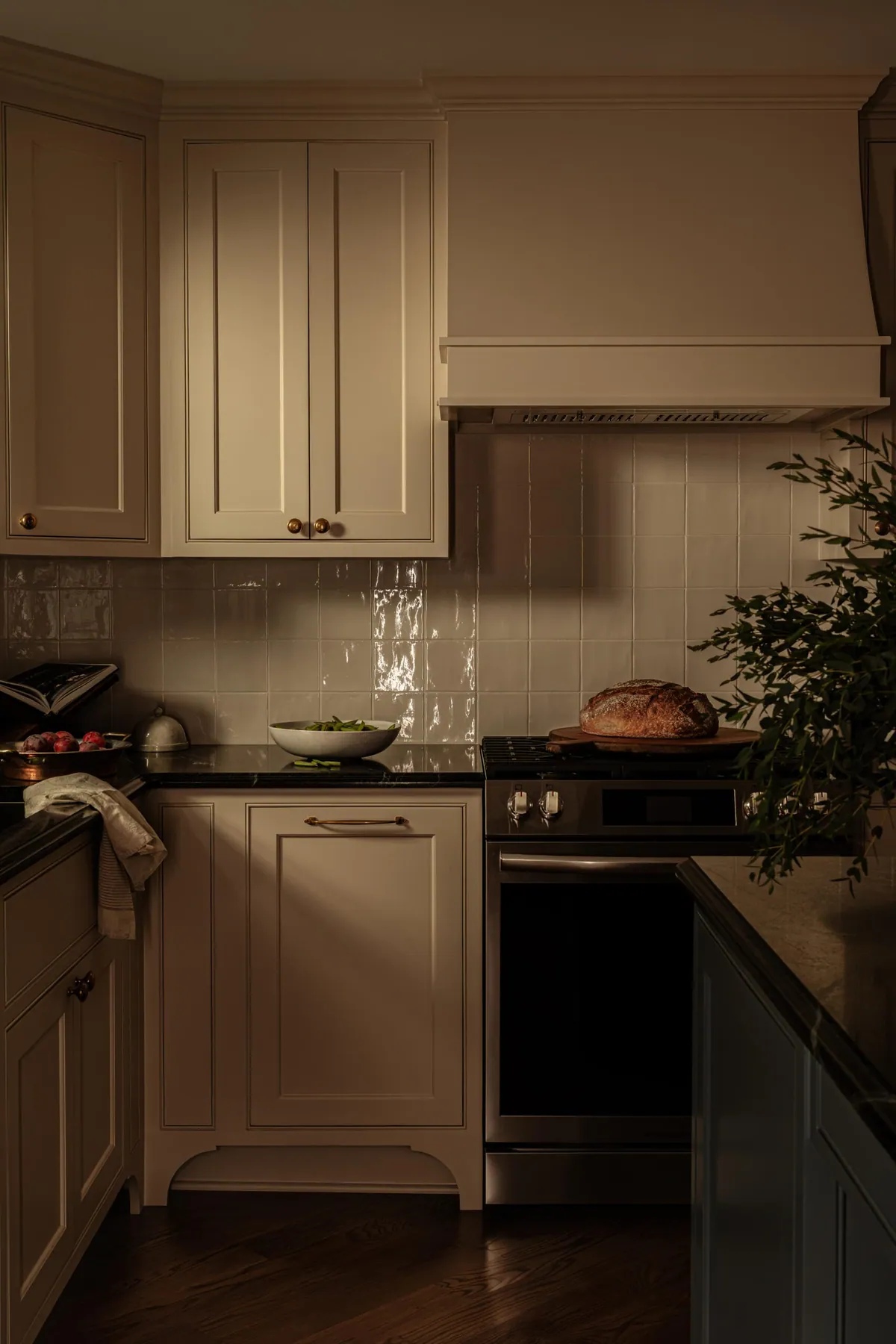 Kitchen range wall with a custom hood and glossy glazed tile backsplash