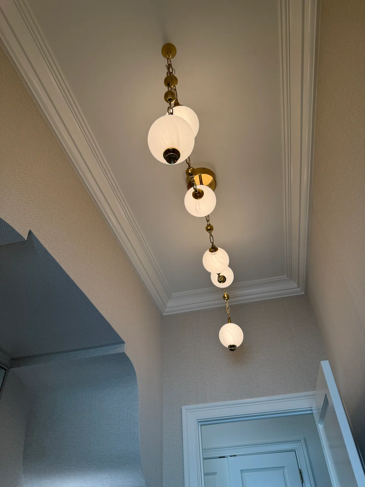 Glass globe lights dropping down a stairwell