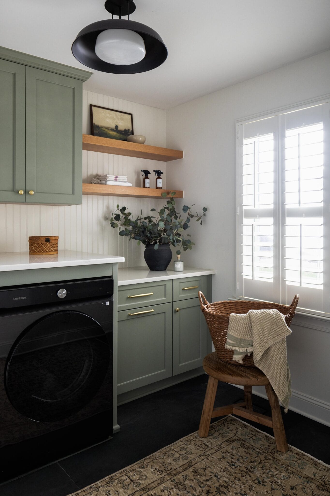 modern clean laundry room design with sage green cabinets