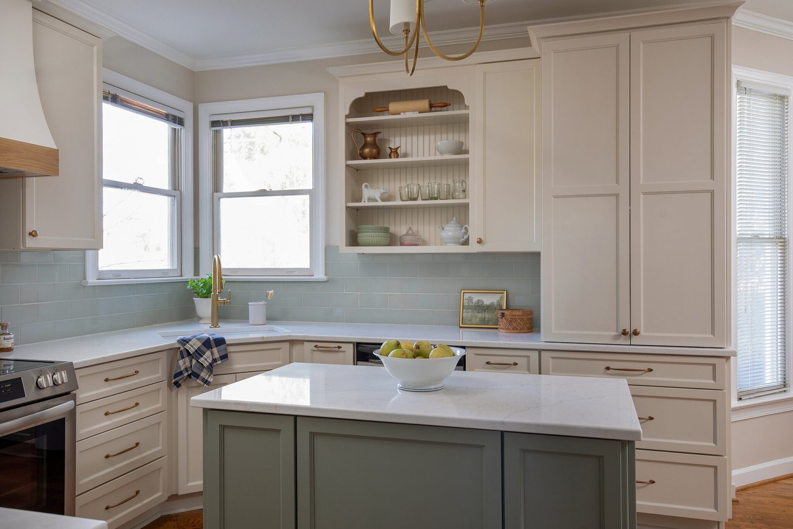 Classic Hilltop Fuquay Varina kitchen renovation with soft green island, appliance garage, white cabinetry, brass hardware, and timeless finishes