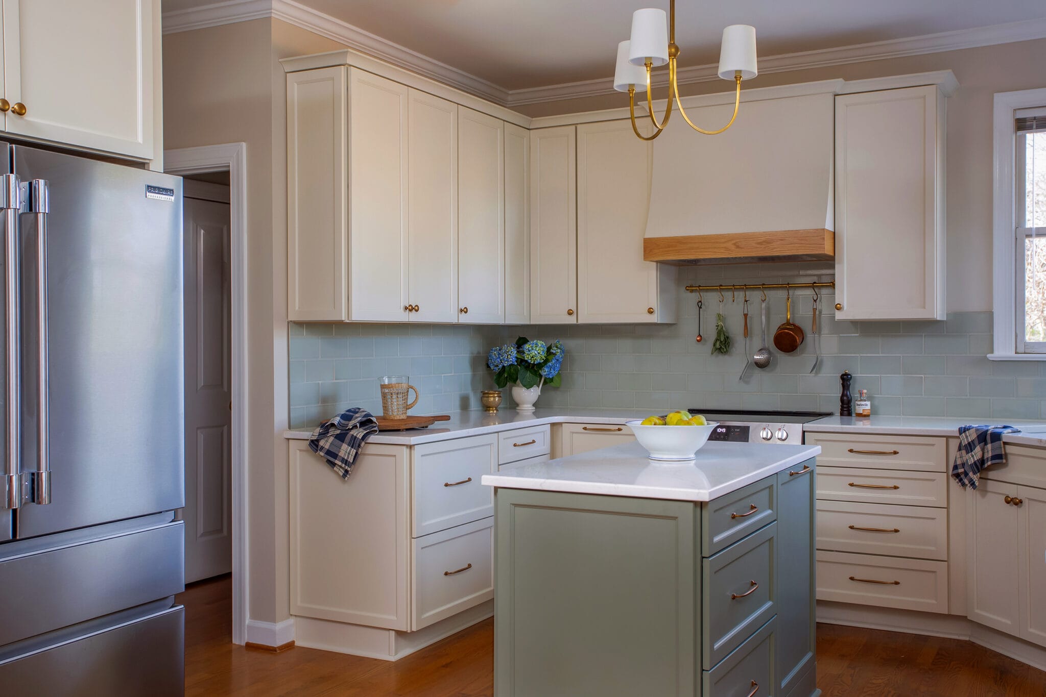 Classic Hilltop Fuquay Varina kitchen renovation with soft green island, white cabinetry, brass hardware, and timeless finishes