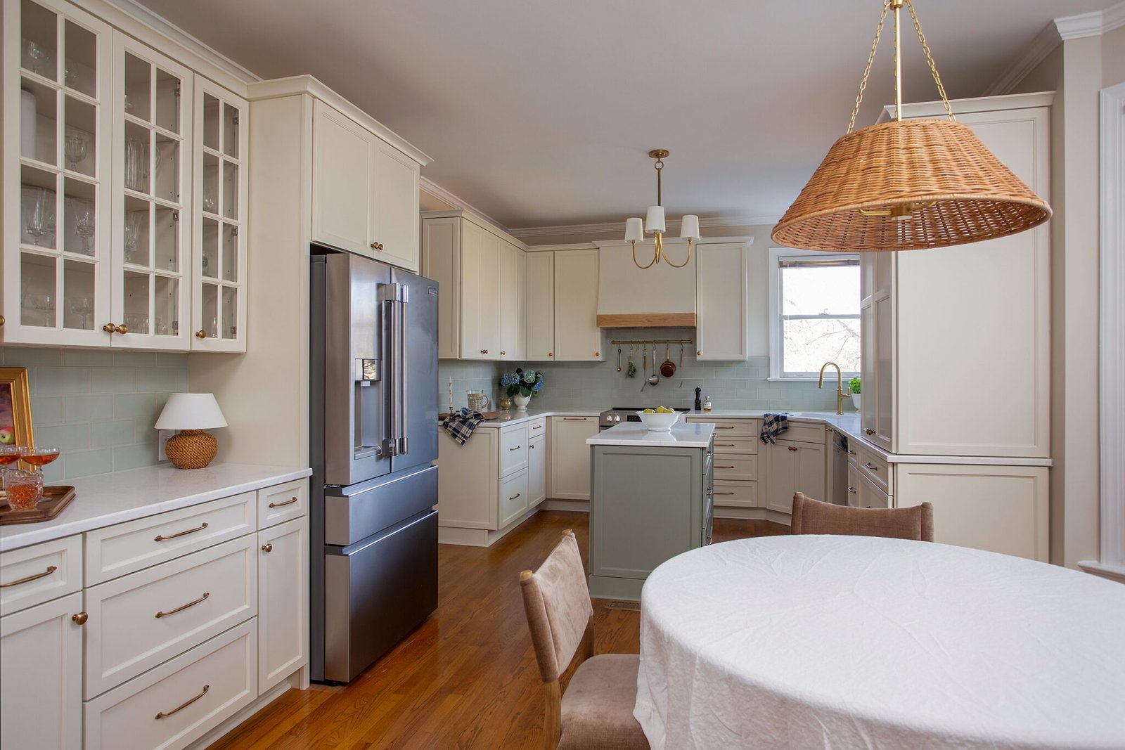 Classic Hilltop Fuquay Varina kitchen renovation with soft green island, white cabinetry, brass hardware, and timeless finishes