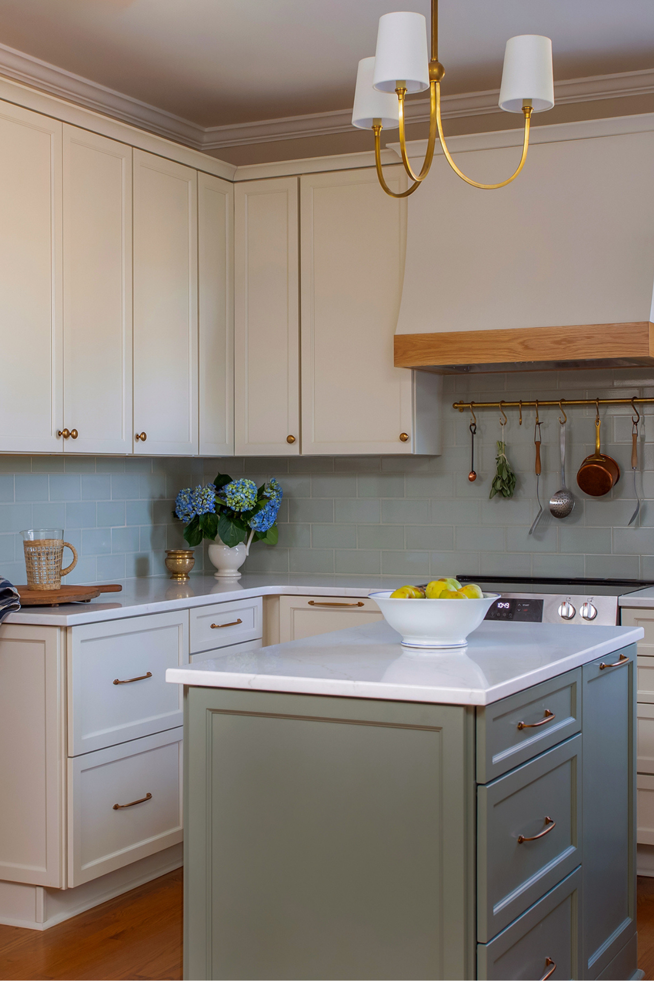 kitchen showing green island and brass hardware